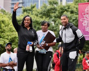 Wanda Cooper-Jones (center), the mother of Ahmaud Arbery, stands with Olympic gold medalist Jackie Joyner-Kersee (left) at the start of the 5K.