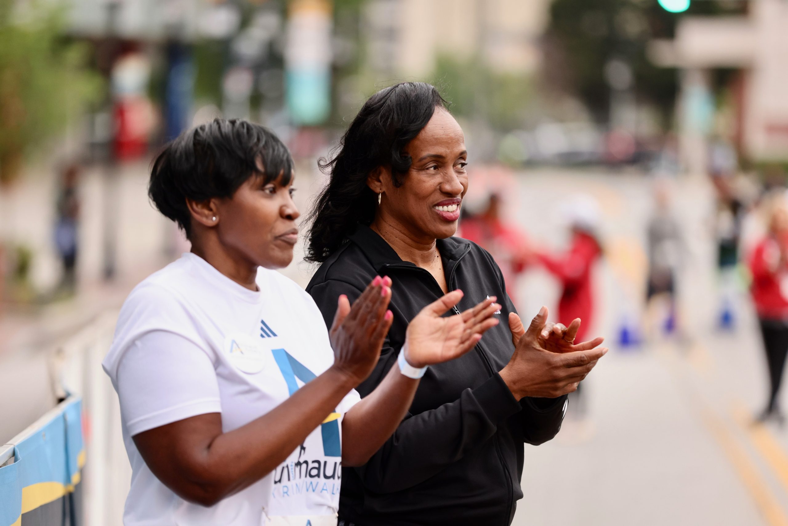 Wanda Cooper-Jones (left), the mother of Ahmaud Arbery, stands with Olympic gold medalist Jackie Joyner-Kersee at the start of the 5K.